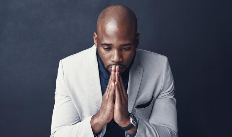 Person with hands together in praying pose