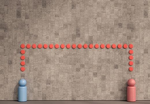Two wooden figurines connected by line of circles