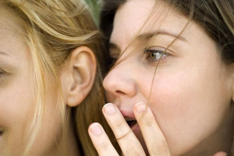 One person whispering to another