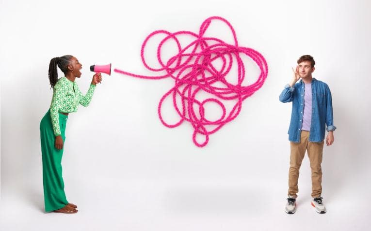 Person yelling through a megaphone, while another tries to tune it out