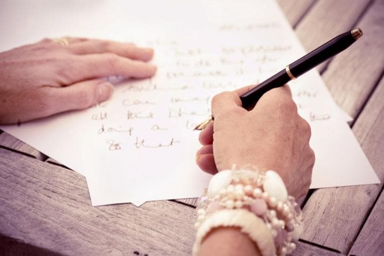 Person writing a letter